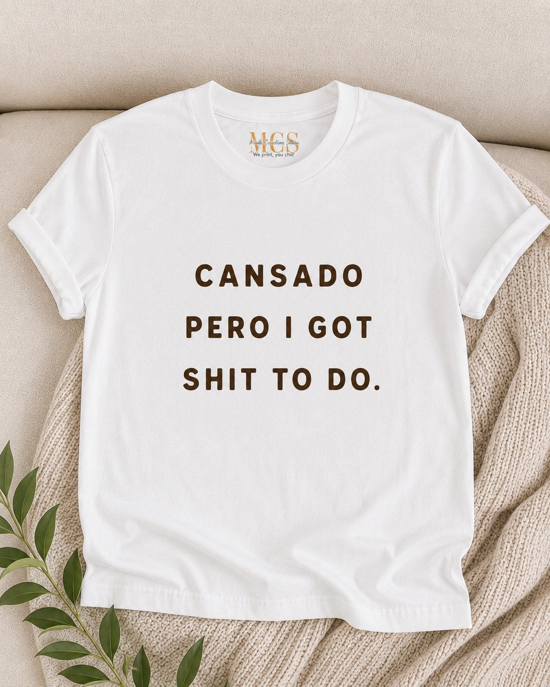 White t-shirt with brown lettering: Cansado pero I got sh*t to do