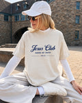 Woman wearing a cream t-shirt printed with Jesus Club, Saved by Faith, John 3:16