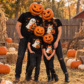 Family of four wearing matching black Halloween t-shirts with a ghost & pumpkin design