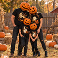 Family of four wearing matching black Halloween t-shirts with a moonlit haunted night design