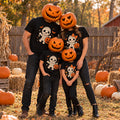 Family of four wearing matching black Halloween t-shirts with a mummy design