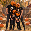 Family of four wearing matching black Halloween t-shirts with a skeleton design