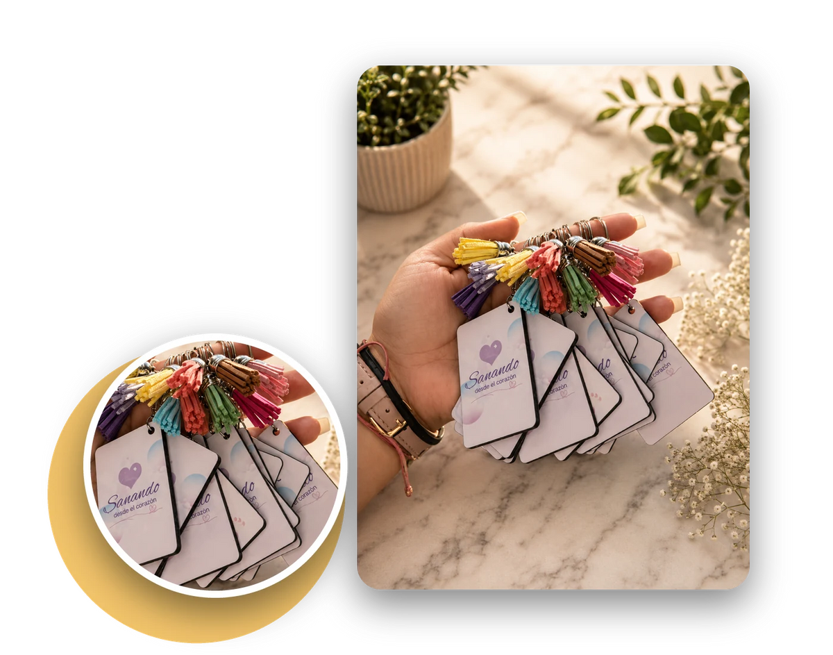 Custom printed keychains with colorful tassels held in hand on a marble table