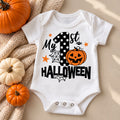 White baby bodysuit with bold My 1st Halloween lettering, a polka-dot number 1 and a jack-o'-lantern