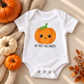 White baby bodysuit with a smiling pumpkin and the words My First Halloween